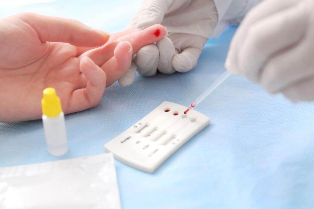 Person having HIV finger prick blood test