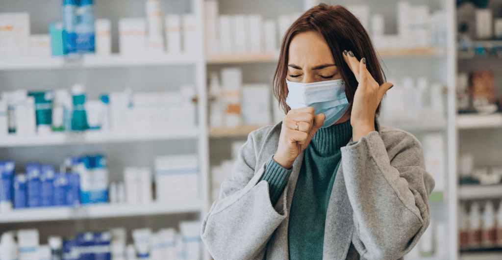 Woman wearing face mask with cough and headache-min