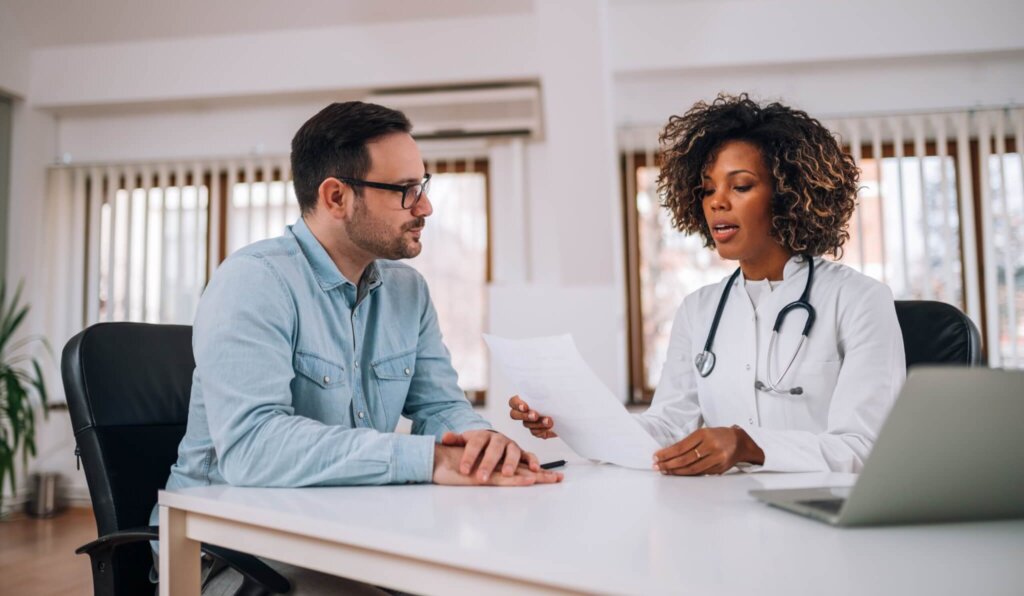 Female doctor consulting with male patient
