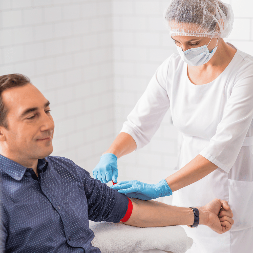 nurse taking blood test from male patient