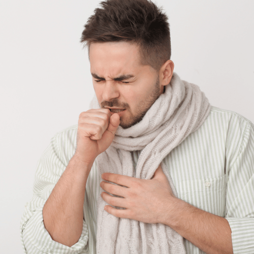 Coughing Young Man on Light Background