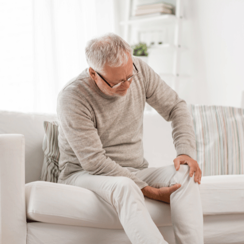 Senior Man Suffering from Knee Ache at Home
