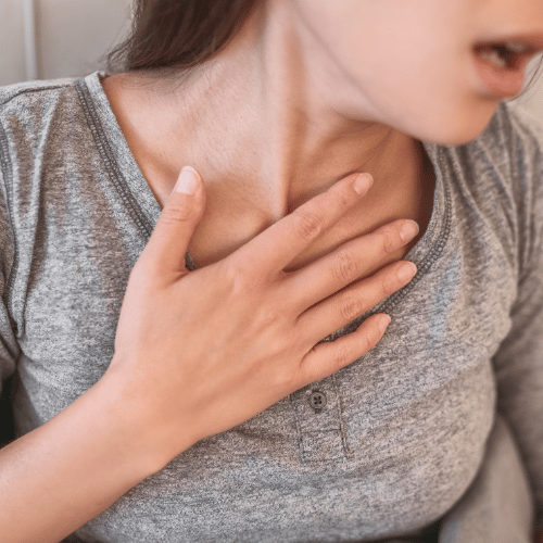 Woman with Hand on Chest Having Difficulty Breathing
