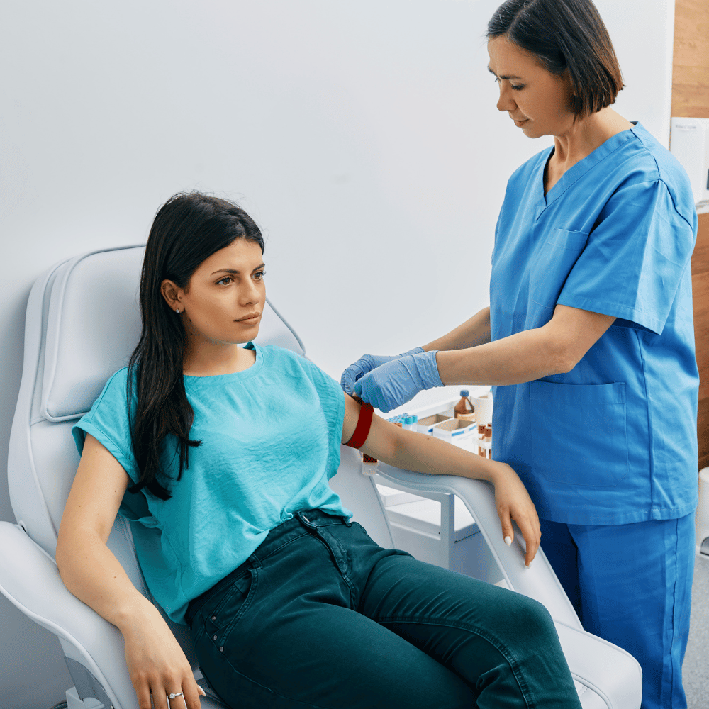 assistant taking blood from a woman for a lactate test