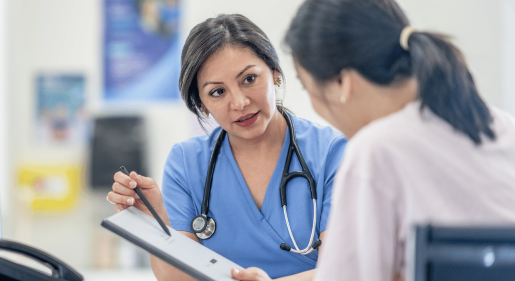 doctor talking to woman patient in the clinic