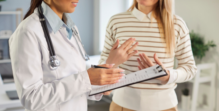A female doctor engaged in conversation with a patient, discussing when to see a private GP for medical advice.